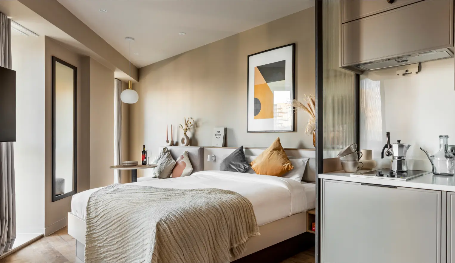 Bedroom/ kitchen area with a white theme